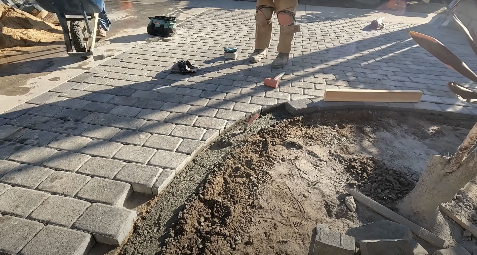 Professional concrete paver installation work in progress Concrete paver installation in progress showing professional laying technique