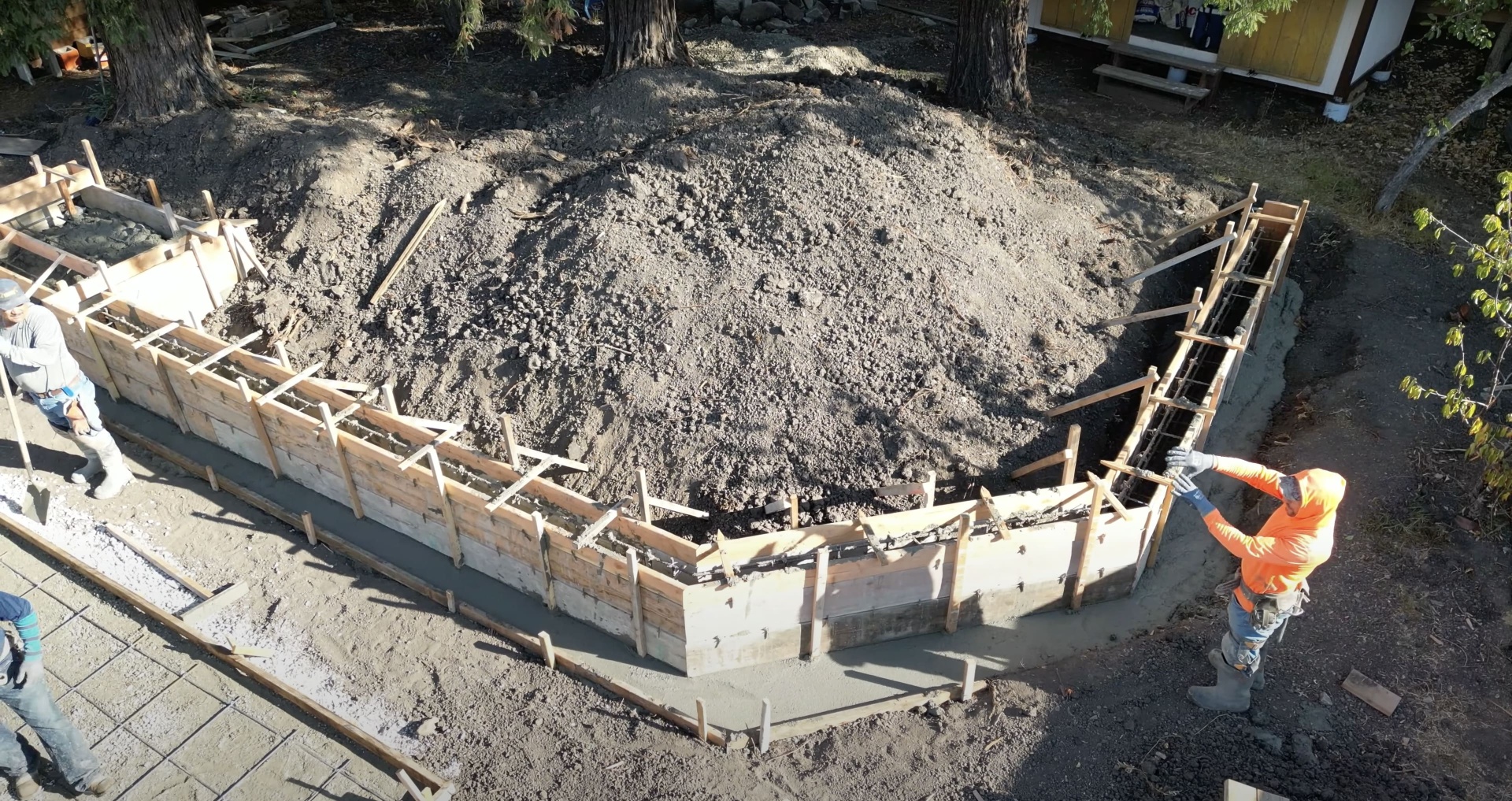 Construction site showing concrete foundation preparation with proper reinforcement