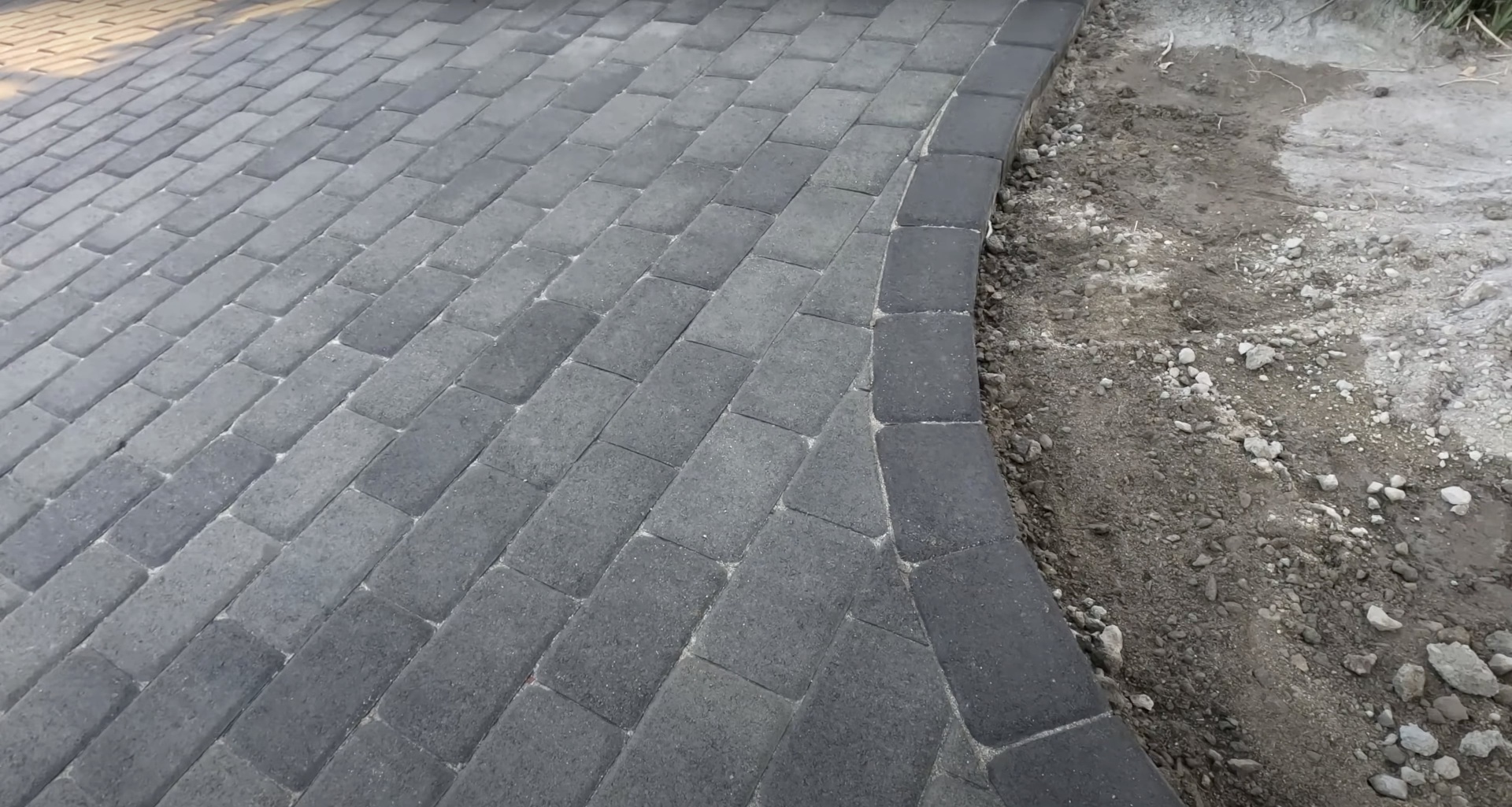Expert concrete paver installation demonstrating precision workmanship Precision concrete paver installation showing expert craftsmanship and alignment